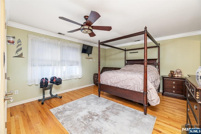 bedroom featuring ceiling fan, ornamental molding, and light hardwood / wood-style flooring