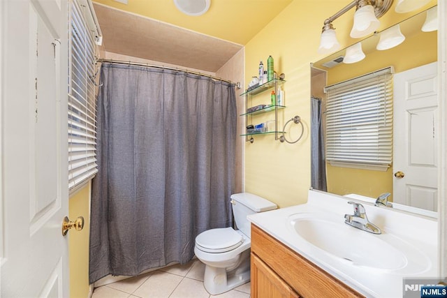 bathroom featuring tile patterned floors, vanity, and toilet