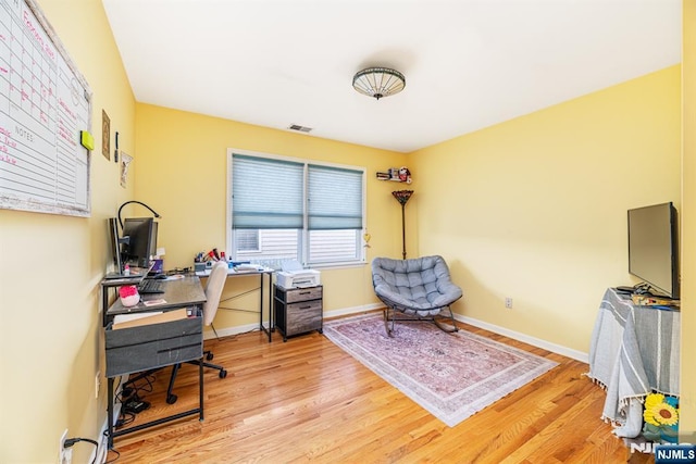 office area with light hardwood / wood-style floors