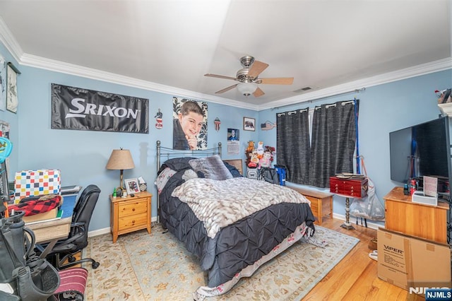 bedroom with light wood-type flooring, crown molding, and ceiling fan