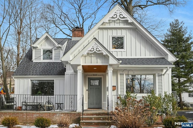 view of front of home with a shingled roof and board and batten siding