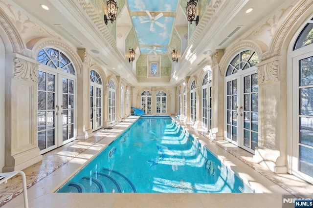 view of swimming pool with french doors