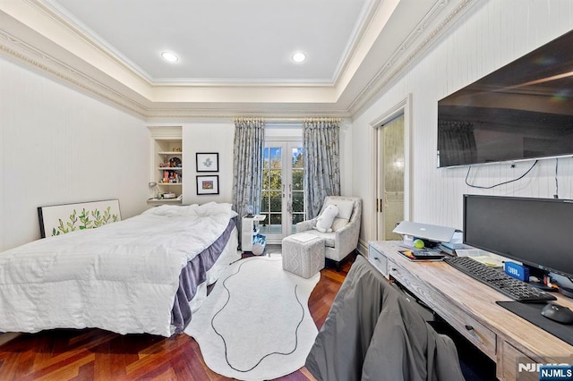 bedroom with a raised ceiling, wood-type flooring, crown molding, and french doors