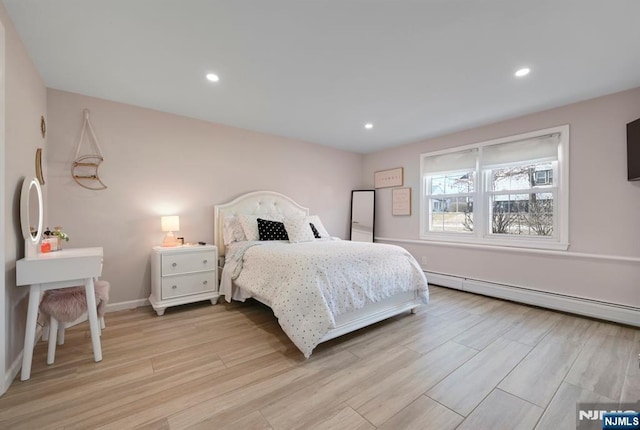 bedroom featuring light wood finished floors, baseboards, baseboard heating, and recessed lighting