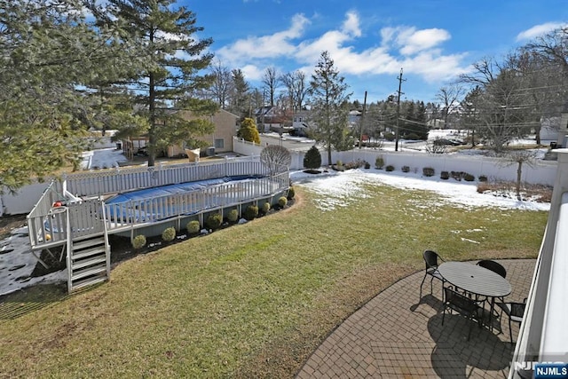 snowy yard with a wooden deck