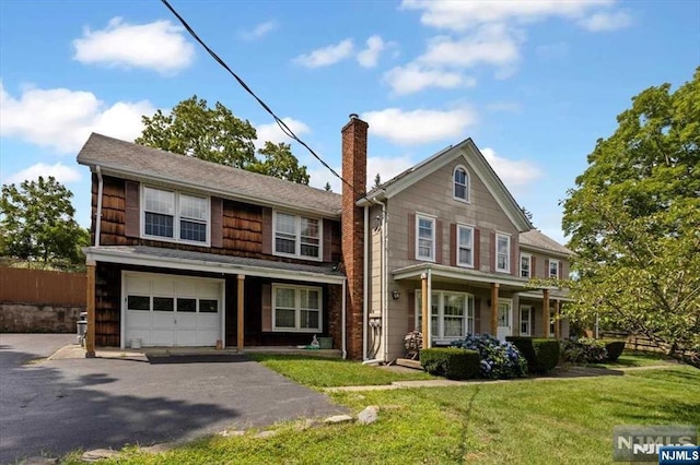 view of front facade with a front lawn and a garage