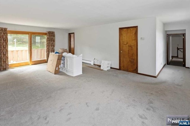 unfurnished room featuring baseboard heating and light colored carpet