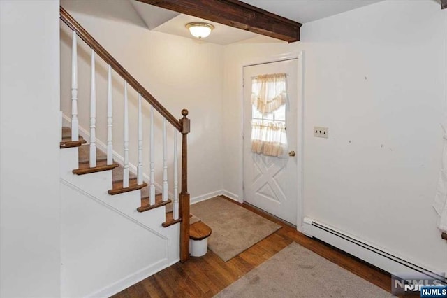 foyer with dark hardwood / wood-style flooring, beamed ceiling, and a baseboard radiator