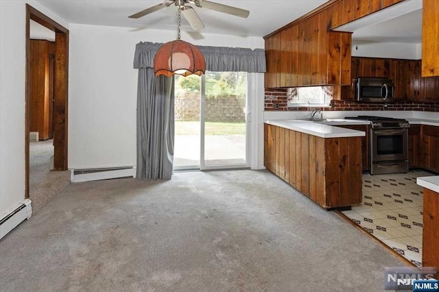 kitchen with light carpet, ceiling fan, stainless steel appliances, and a baseboard heating unit