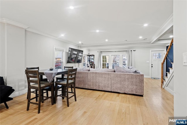 dining area featuring light wood-type flooring and crown molding