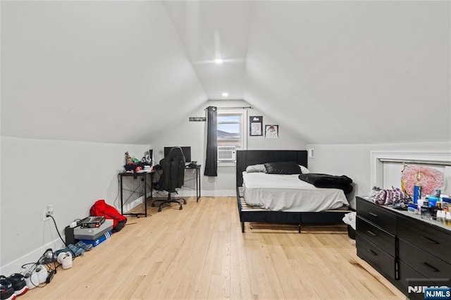 bedroom featuring light hardwood / wood-style floors and vaulted ceiling