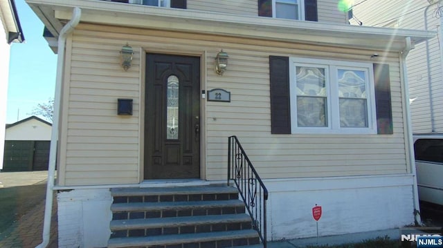 entrance to property with a detached garage