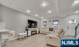 living room featuring a fireplace and light hardwood / wood-style floors