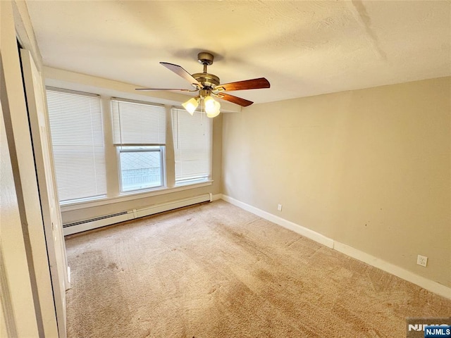 empty room featuring carpet, ceiling fan, and a baseboard radiator