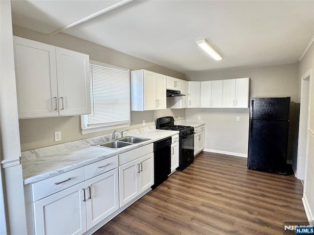 kitchen featuring white cabinetry, sink, black appliances, and dark wood-type flooring