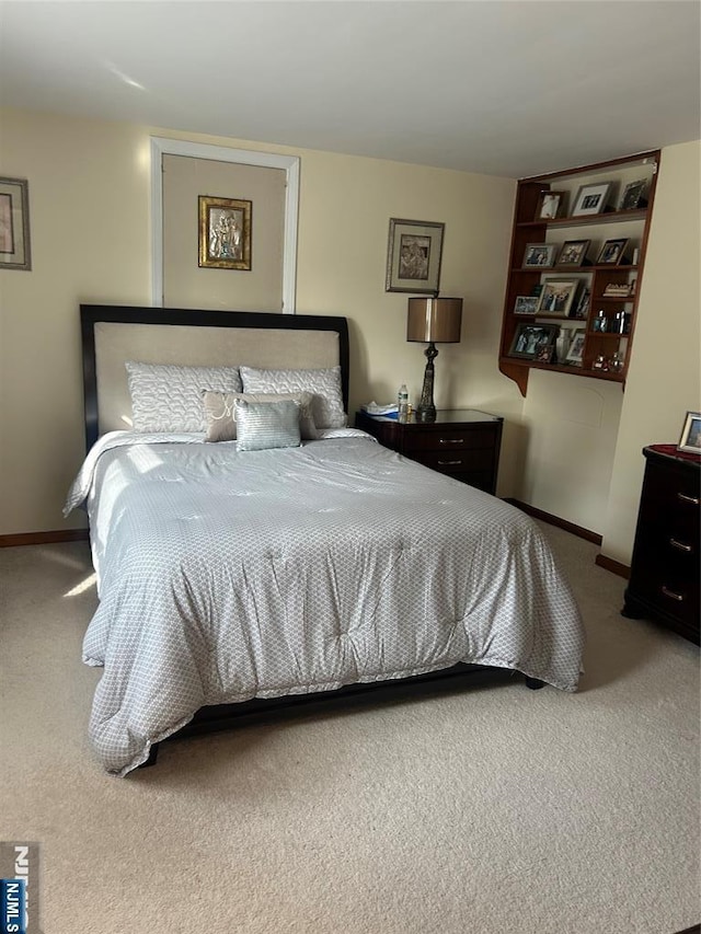 bedroom featuring carpet floors and baseboards