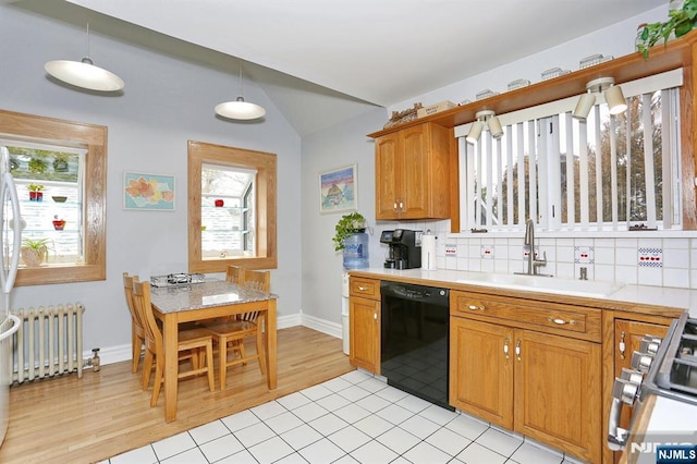 kitchen featuring a sink, radiator heating unit, light countertops, and dishwasher