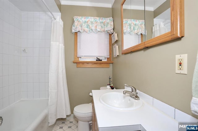 bathroom with toilet, crown molding, vanity, and shower / tub combo with curtain