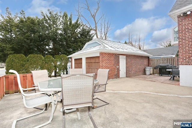 view of patio / terrace featuring outdoor dining space, a grill, and fence