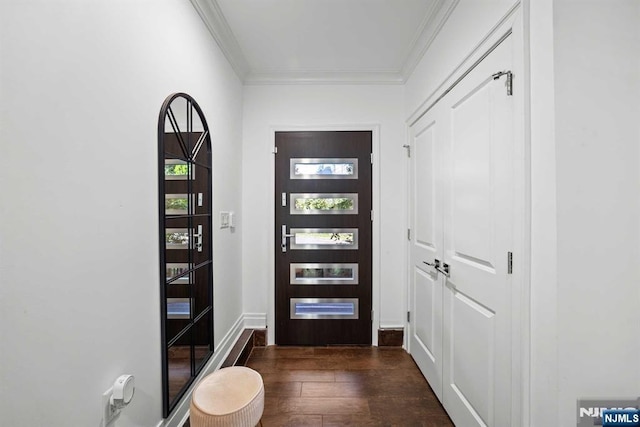 foyer entrance featuring crown molding and dark hardwood / wood-style floors