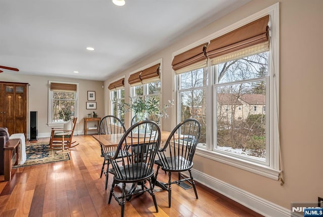 dining area with recessed lighting, baseboards, and hardwood / wood-style flooring