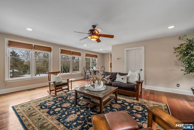 living room featuring recessed lighting, visible vents, baseboards, and wood finished floors