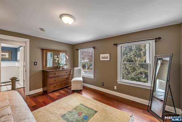 living area featuring dark wood-style floors and baseboards