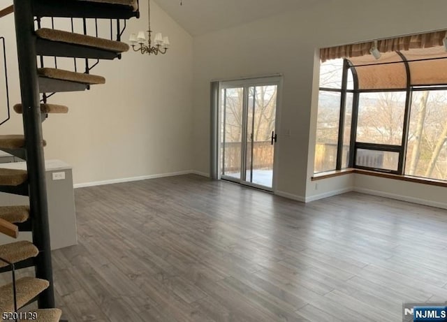 interior space with lofted ceiling, dark hardwood / wood-style flooring, and a chandelier