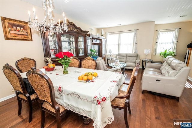 dining room featuring a chandelier and dark hardwood / wood-style flooring