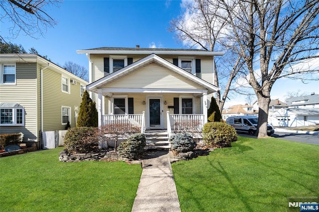 view of front of home with covered porch and a front lawn