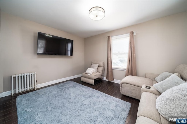 living room featuring radiator heating unit and dark hardwood / wood-style floors