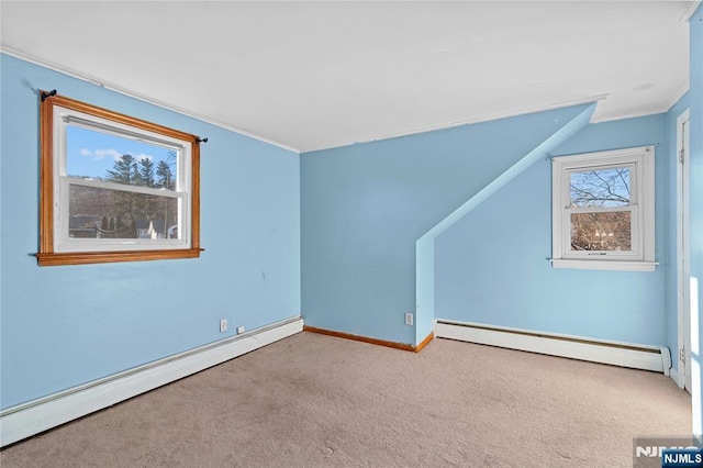 bonus room featuring a baseboard heating unit and light carpet