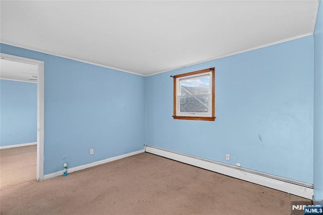 carpeted spare room featuring a baseboard heating unit and ornamental molding