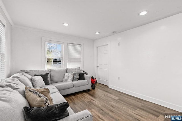 living room with crown molding and hardwood / wood-style floors