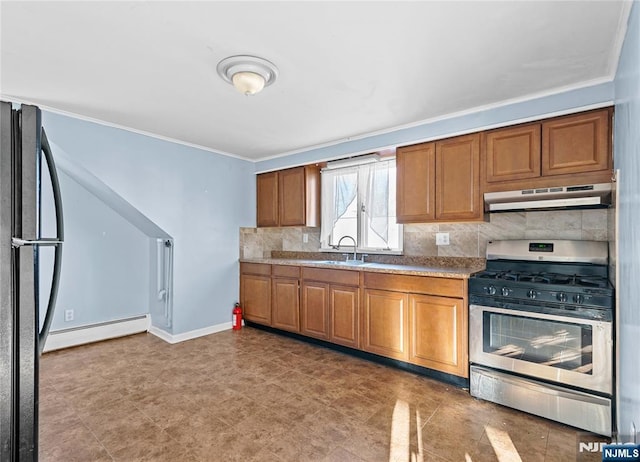 kitchen with sink, backsplash, black fridge, stainless steel range with gas cooktop, and baseboard heating