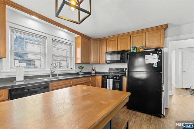 kitchen featuring light hardwood / wood-style flooring, sink, and black appliances