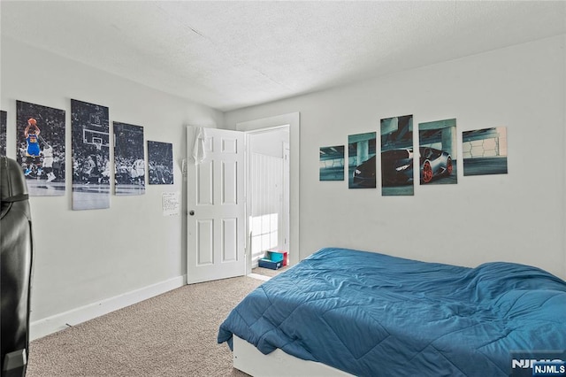 carpeted bedroom with a textured ceiling