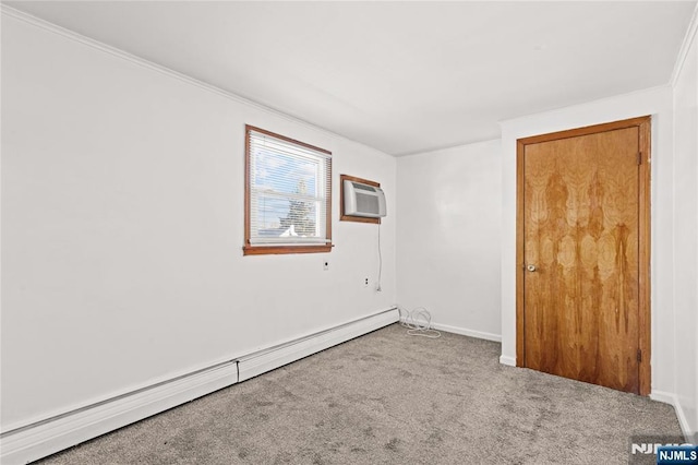 carpeted spare room with a baseboard heating unit and a wall mounted AC