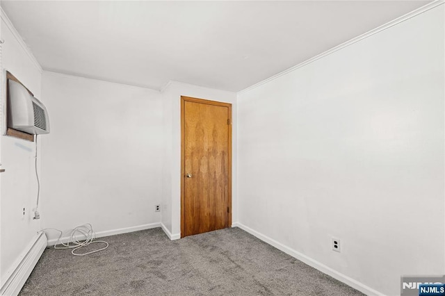 carpeted spare room featuring ornamental molding