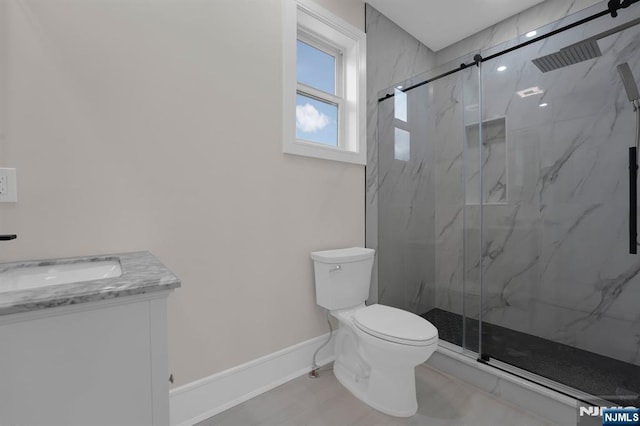 bathroom featuring vanity, toilet, and walk in shower