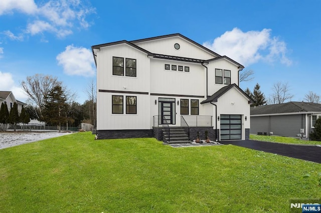 view of front of home with a front lawn and a garage