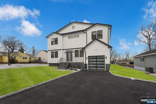 modern farmhouse with a garage, central air condition unit, and a front lawn