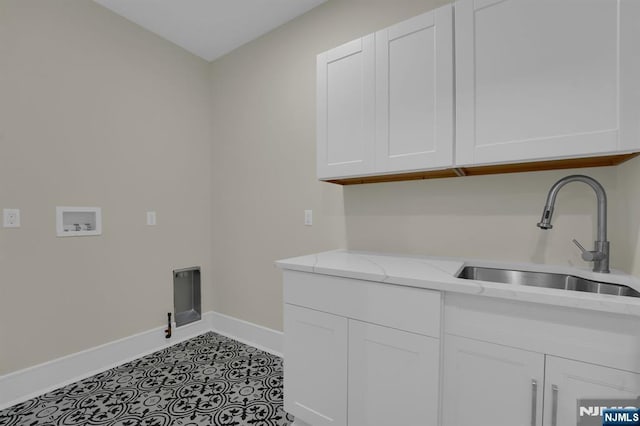 laundry area with cabinets, gas dryer hookup, hookup for a washing machine, sink, and light tile patterned floors