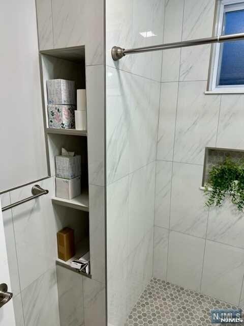 bathroom with tiled shower