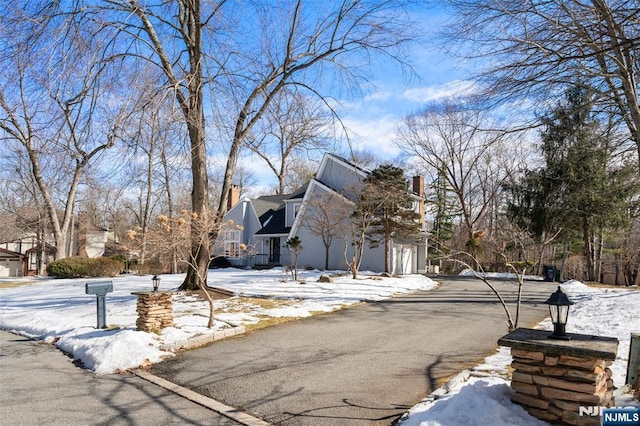 view of snowy exterior with a garage