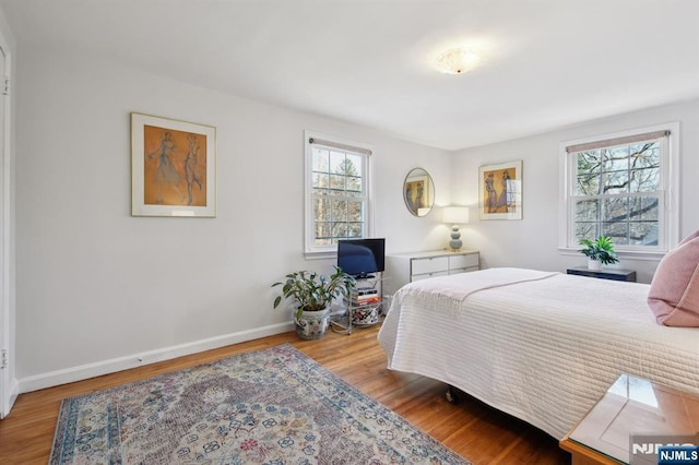 bedroom featuring light wood-type flooring and baseboards