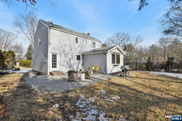 back of property with entry steps, a patio, and fence