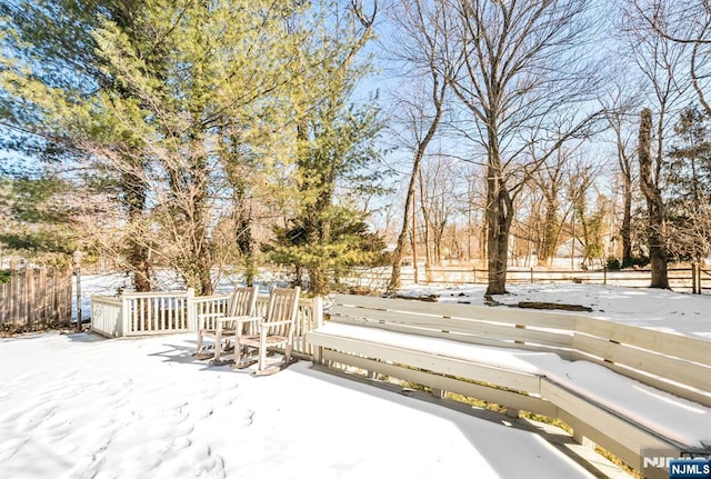 yard covered in snow with fence