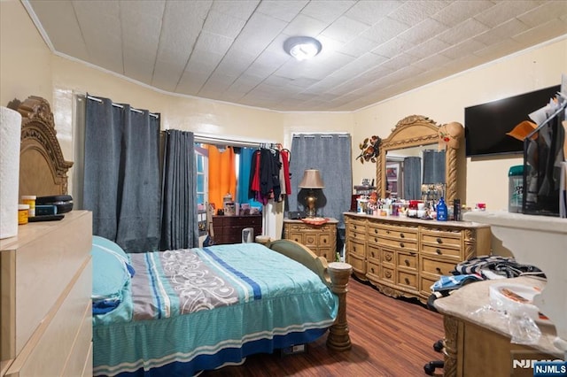 bedroom with ornamental molding and hardwood / wood-style flooring