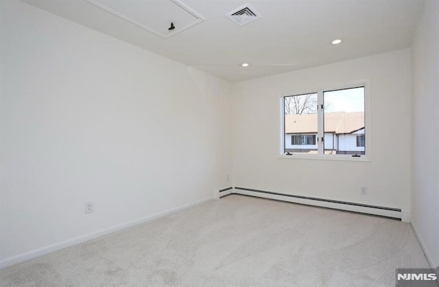 empty room with light carpet and a baseboard radiator